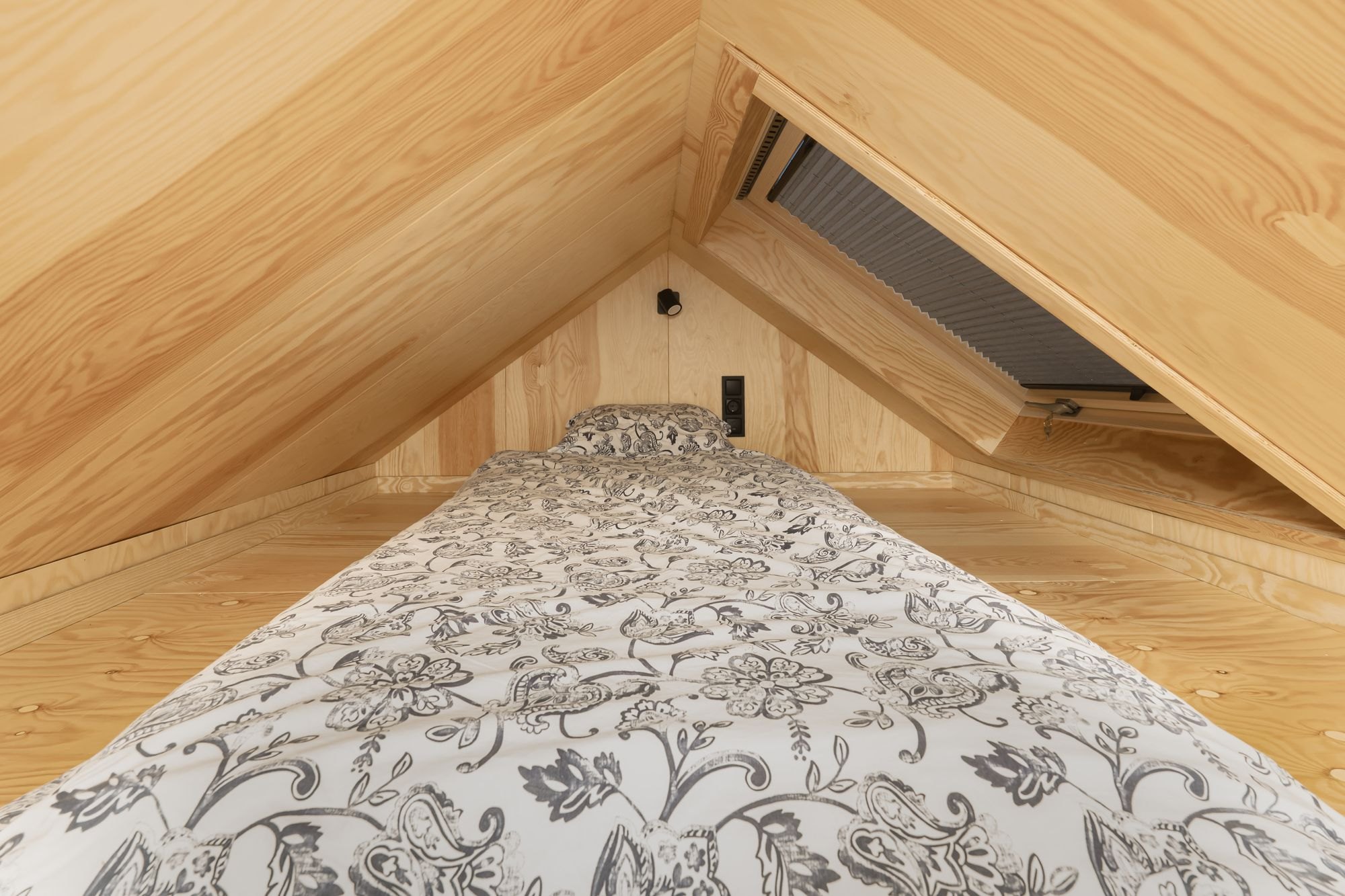 A real loft, photographed at its real height. Sleeping space, and a good deal of it.